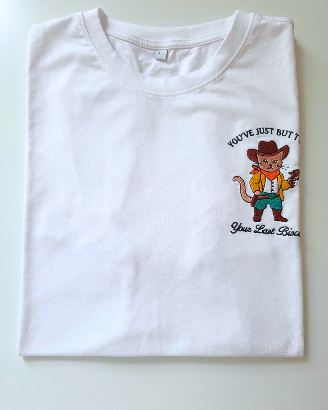 "You've just buttered your last biscuit" - cowboy cat embroidered t-shirt